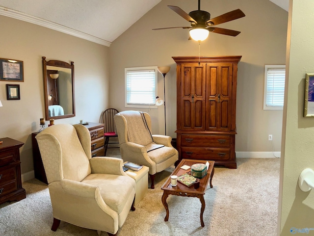 carpeted living room featuring ornamental molding, lofted ceiling, and ceiling fan