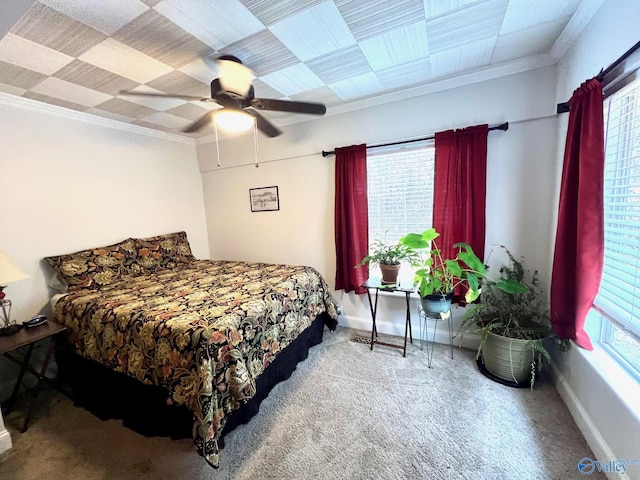 carpeted bedroom with multiple windows, crown molding, and ceiling fan