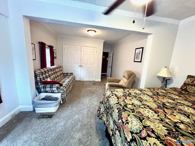 bedroom with ornamental molding, carpet floors, ceiling fan, and a closet