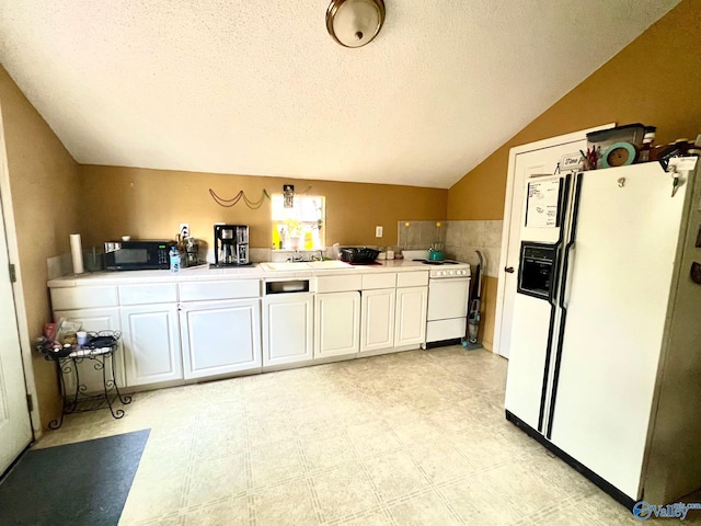 kitchen featuring vaulted ceiling, white cabinetry, sink, white appliances, and a textured ceiling