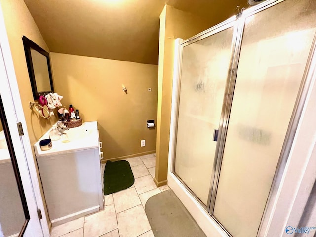 bathroom featuring vaulted ceiling, vanity, tile patterned floors, and a shower with shower door