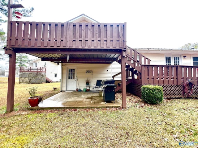 back of house featuring a patio, a deck, and a lawn