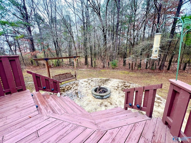 wooden deck with an outdoor fire pit