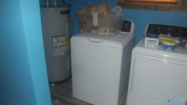 laundry room with independent washer and dryer, wood-type flooring, and electric water heater