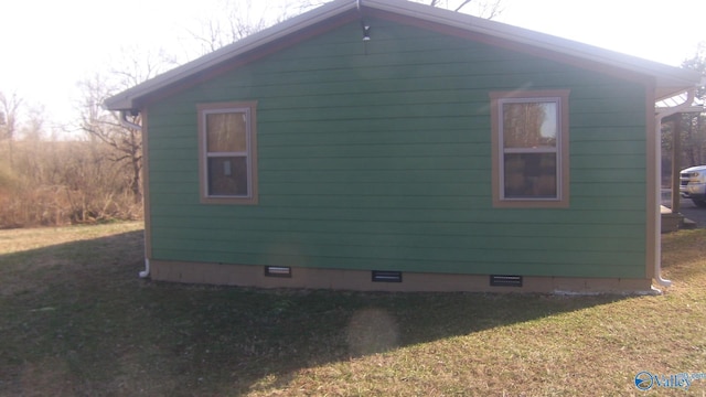 view of side of home featuring a lawn