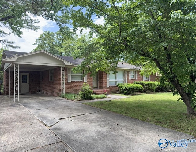215 Wingate Ave, Huntsville, AL 35802 - ranch-style house featuring concrete driveway, brick siding, a front yard, and an attached carport