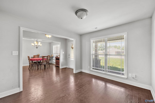 interior space featuring an inviting chandelier and dark hardwood / wood-style floors