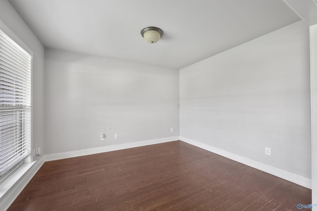 unfurnished room featuring dark wood-type flooring