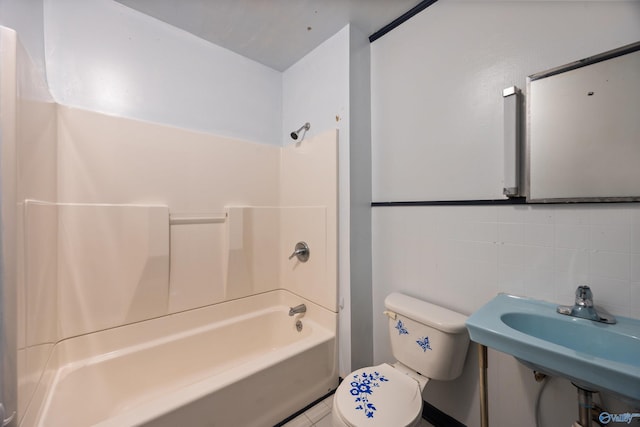 full bath with a sink, backsplash, bathtub / shower combination, and toilet
