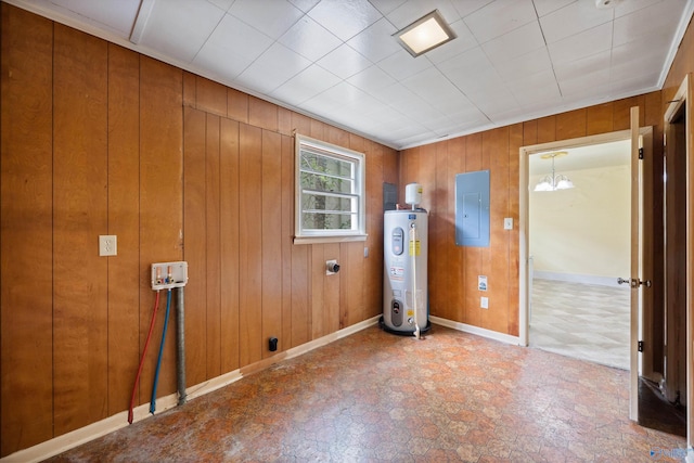 interior space with laundry area, electric panel, wood walls, baseboards, and water heater