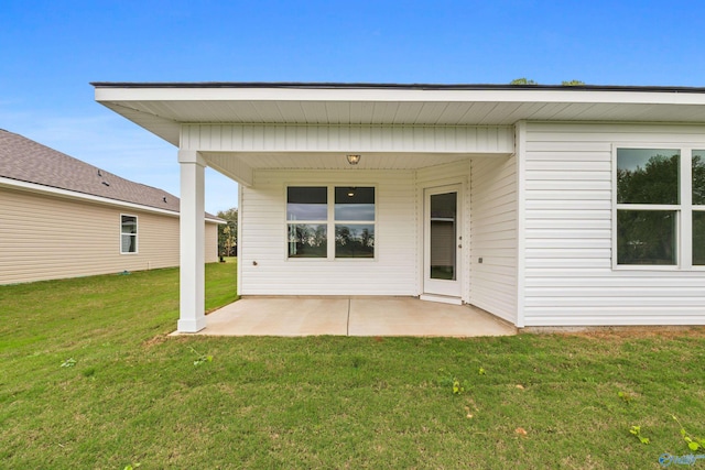 back of property featuring a yard and a patio