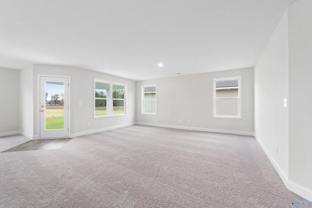 spare room featuring light colored carpet