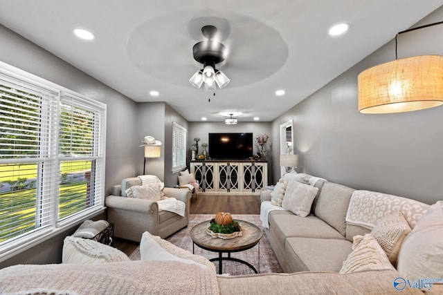 living room featuring ceiling fan, hardwood / wood-style flooring, and lofted ceiling