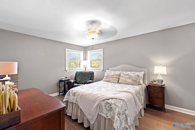 bedroom with ceiling fan and dark hardwood / wood-style flooring