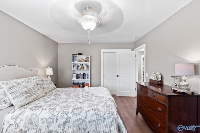 bedroom with ceiling fan and wood-type flooring