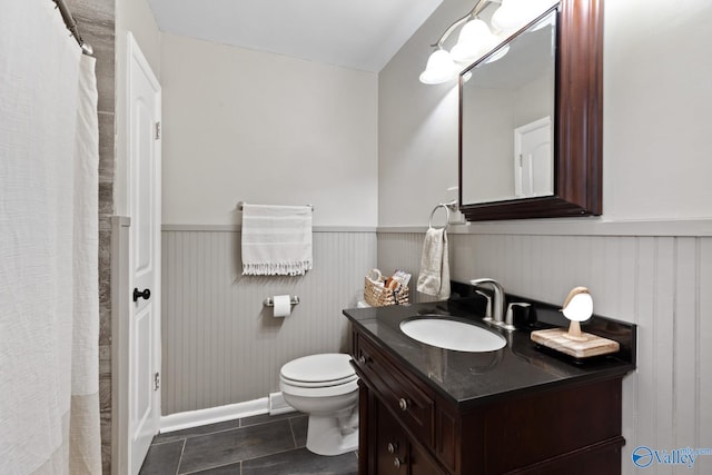 bathroom with vanity, toilet, and tile patterned floors