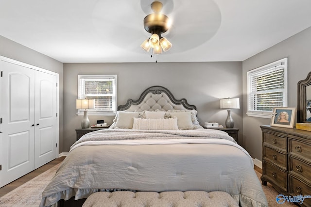 bedroom featuring hardwood / wood-style flooring, ceiling fan, and a closet