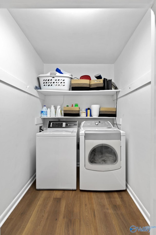 washroom with dark hardwood / wood-style floors and separate washer and dryer