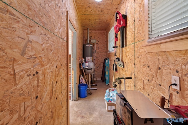 hallway with gas water heater and concrete flooring