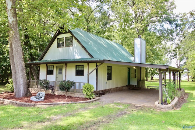17395 County Road 31, Centre, AL 35960 - view of front of home with an attached carport, a front yard, a porch, a chimney, and metal roof