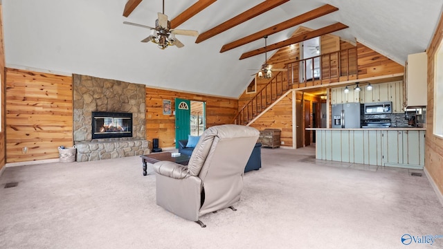 17395 County Road 31, Centre, AL 35960 - living area featuring stairway, wooden walls, light carpet, and ceiling fan