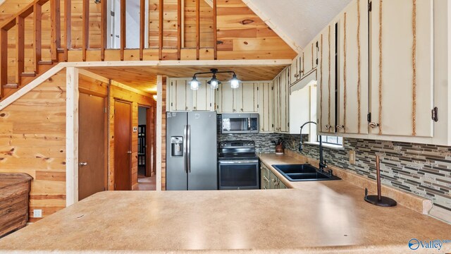 17395 County Road 31, Centre, AL 35960 - kitchen with a sink, decorative backsplash, vaulted ceiling, light countertops, and appliances with stainless steel finishes