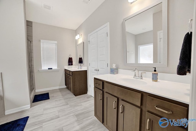 bathroom featuring vanity and an enclosed shower