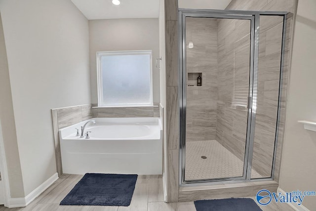 bathroom with shower with separate bathtub