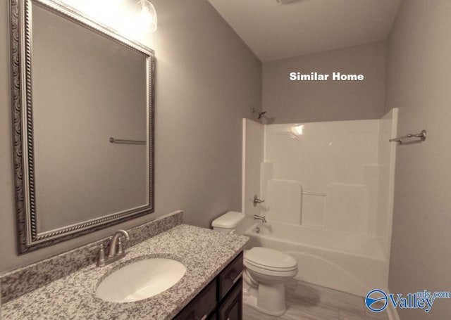 full bathroom featuring shower / bathing tub combination, vanity, and toilet