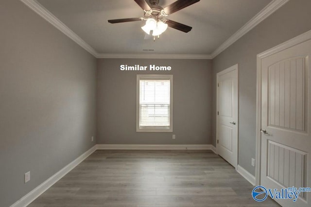 unfurnished bedroom featuring ornamental molding, baseboards, light wood finished floors, and a ceiling fan