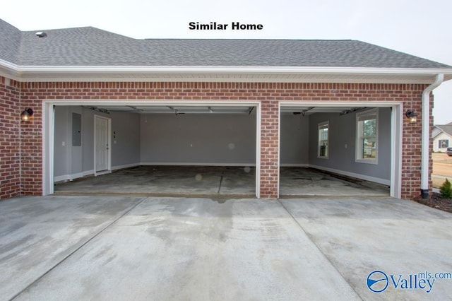 garage featuring driveway and electric panel