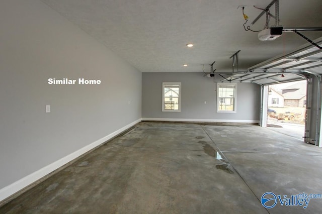 garage featuring a garage door opener and baseboards