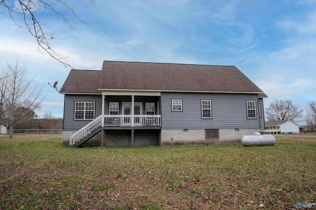 back of property featuring a yard