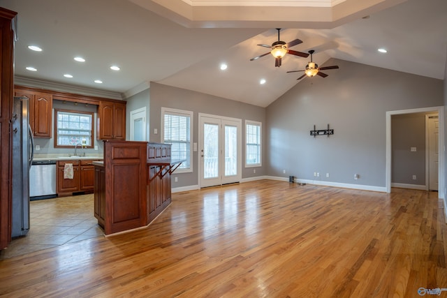 kitchen featuring high vaulted ceiling, sink, ornamental molding, stainless steel appliances, and light hardwood / wood-style flooring