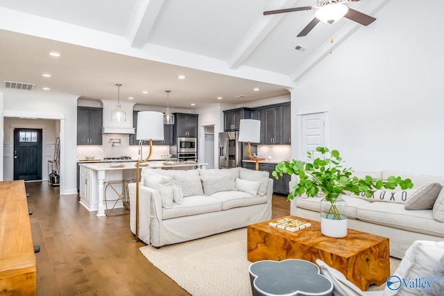 living room featuring beam ceiling, ceiling fan, high vaulted ceiling, and dark wood-type flooring