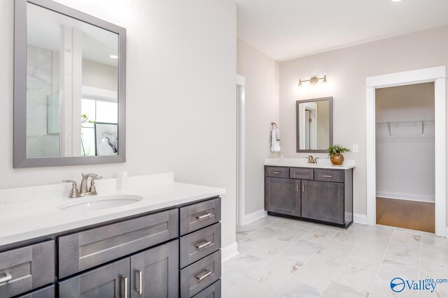 bathroom with dual vanity and tile patterned floors