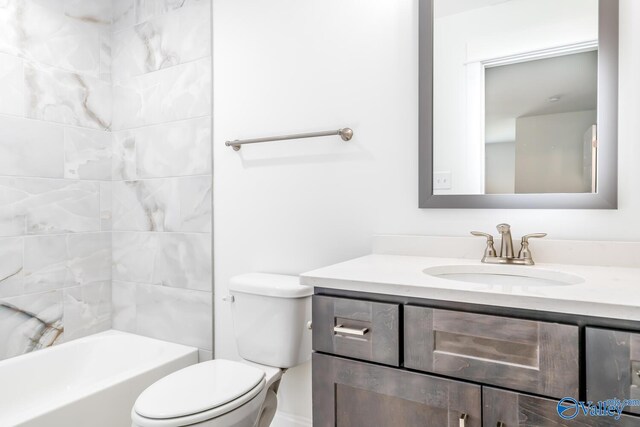 full bathroom with tiled shower / bath combo, vanity, and toilet