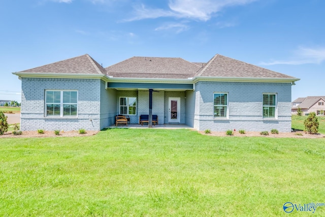 rear view of house featuring a lawn