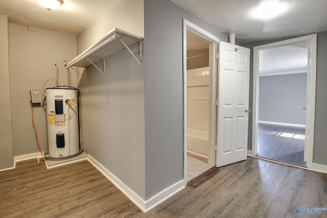 interior space with water heater and wood-type flooring