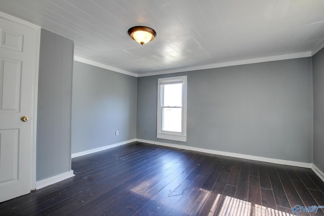 unfurnished room with crown molding and dark wood-type flooring