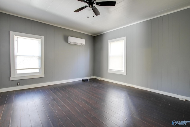 spare room featuring ornamental molding, dark hardwood / wood-style floors, a wall mounted air conditioner, and ceiling fan