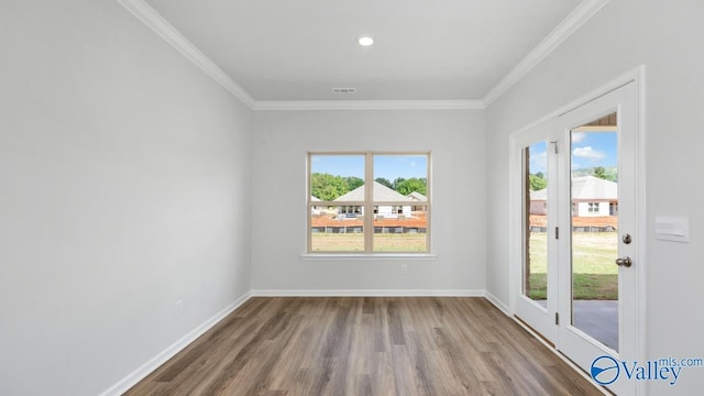 unfurnished room with wood-type flooring and ornamental molding