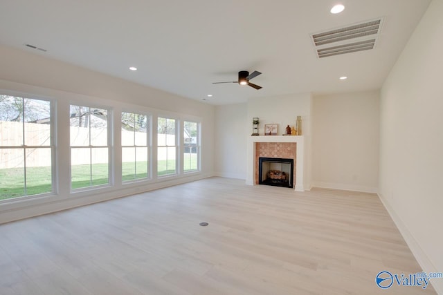 unfurnished living room with ceiling fan and light wood-type flooring