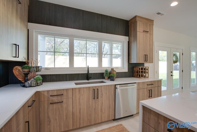 kitchen with dishwasher, a healthy amount of sunlight, sink, and french doors