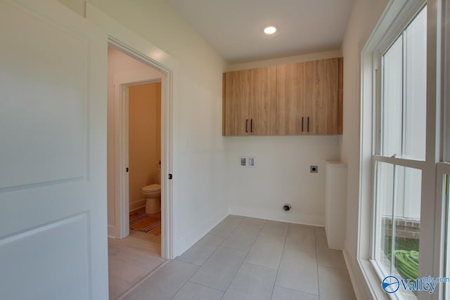 clothes washing area with cabinets, hookup for a washing machine, light tile patterned floors, and electric dryer hookup