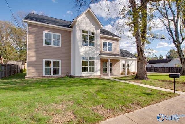 rear view of house featuring a yard