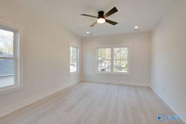 unfurnished room featuring light hardwood / wood-style flooring, a wealth of natural light, and ceiling fan