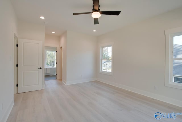 spare room featuring ceiling fan and light hardwood / wood-style flooring