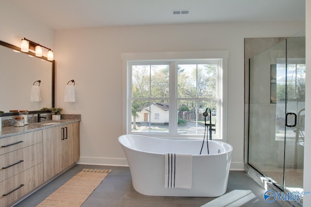 bathroom with vanity and separate shower and tub