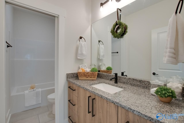 bathroom with tile patterned floors, vanity, and toilet